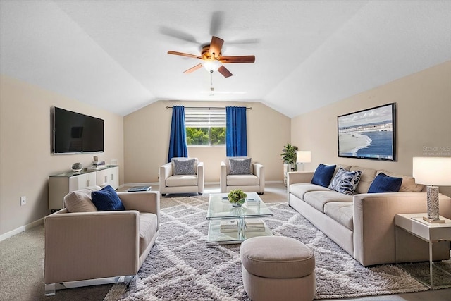 carpeted living room with vaulted ceiling, baseboards, and ceiling fan