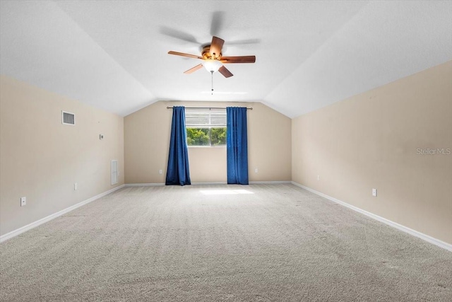 bonus room with vaulted ceiling, visible vents, ceiling fan, and light carpet