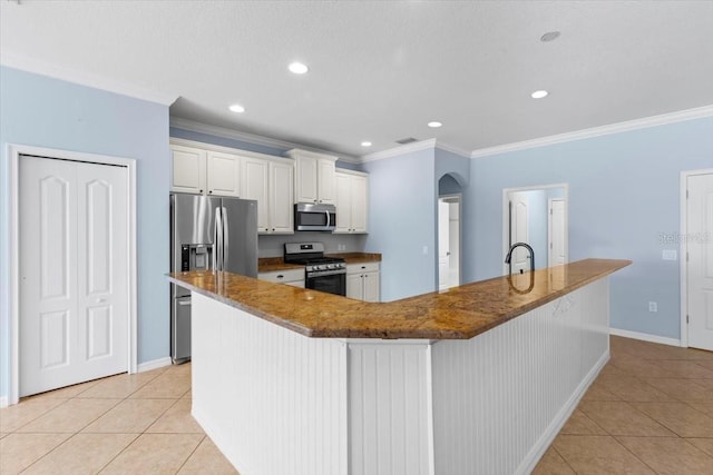 kitchen featuring ornamental molding, stainless steel appliances, light tile patterned flooring, and a sink