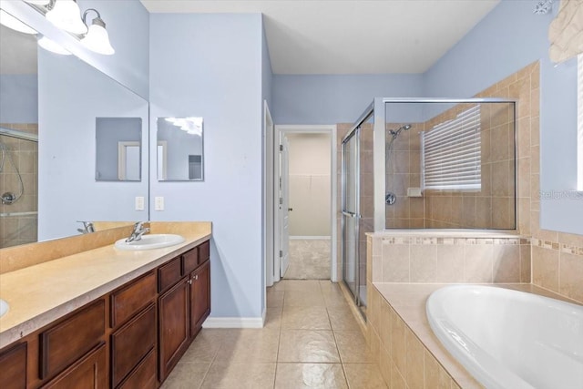 bathroom with a sink, tile patterned flooring, a shower stall, double vanity, and a bath