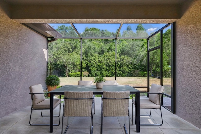 sunroom / solarium featuring outdoor dining space