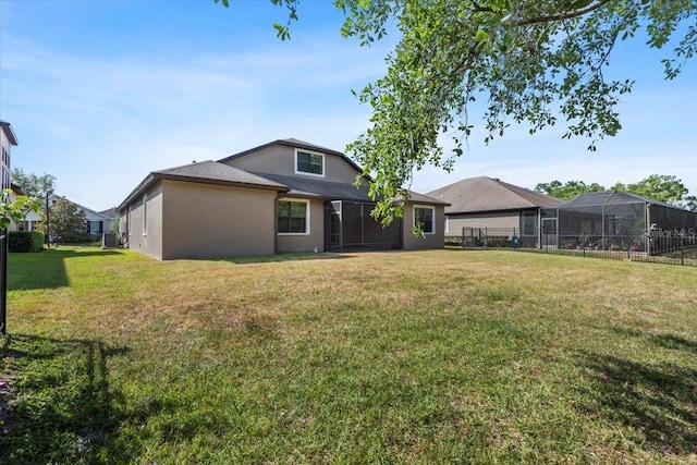 back of property with central air condition unit, stucco siding, fence, and a lawn