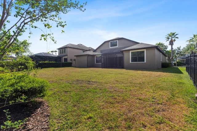 view of yard with a sunroom and fence