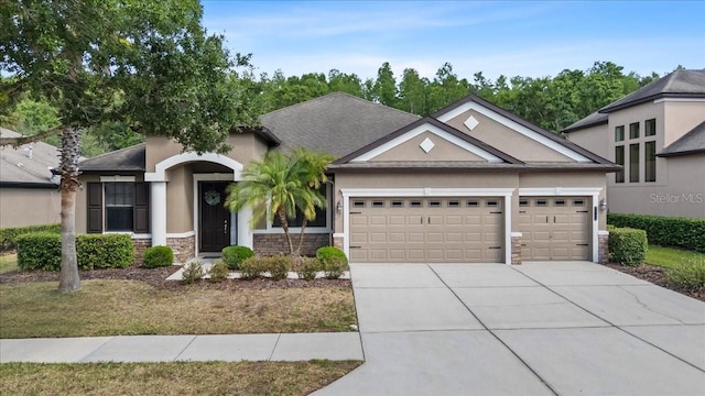 view of front of property with an attached garage, stone siding, driveway, stucco siding, and a shingled roof