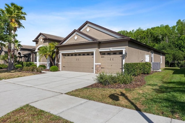 view of front of home with a garage, stucco siding, concrete driveway, stone siding, and a front lawn