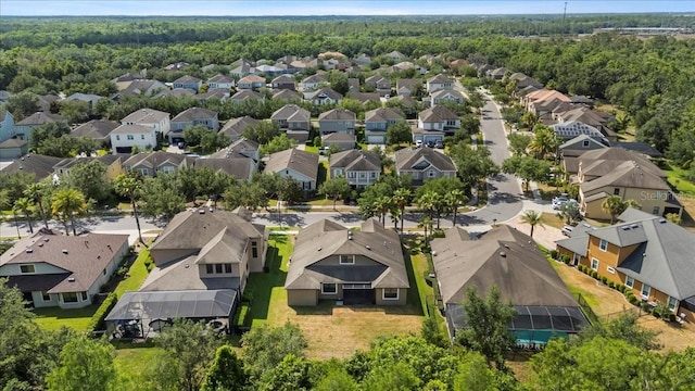 birds eye view of property featuring a forest view and a residential view
