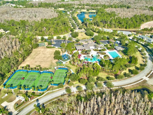 drone / aerial view featuring a water view and a view of trees