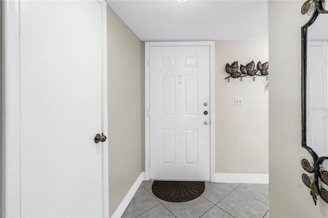 6011 Bahia Del Mar Blvd Unit 158, Saint Petersburg, FL 33715 - foyer entrance with light tile patterned floors, baseboards, and a textured ceiling