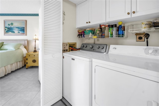 6011 Bahia Del Mar Blvd Unit 158, Saint Petersburg, FL 33715 - washroom with cabinet space, washing machine and dryer, and light tile patterned floors