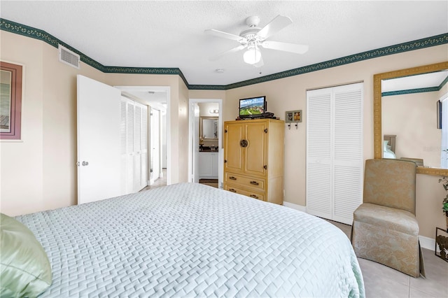 6011 Bahia Del Mar Blvd Unit 158, Saint Petersburg, FL 33715 - bedroom featuring a closet, baseboards, light tile patterned floors, a textured ceiling, and ceiling fan