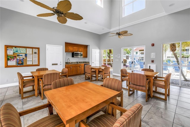 6011 Bahia Del Mar Blvd Unit 158, Saint Petersburg, FL 33715 - dining area with a towering ceiling, healthy amount of natural light, ceiling fan, and baseboards