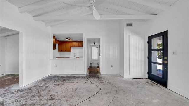 unfurnished living room featuring a ceiling fan, visible vents, a sink, and lofted ceiling