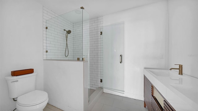 full bathroom with vanity, tile patterned floors, a stall shower, and toilet