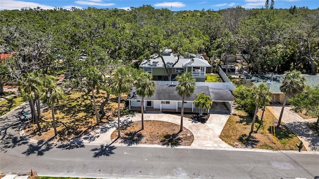 birds eye view of property featuring a wooded view