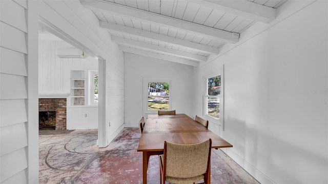dining room featuring lofted ceiling with beams, a brick fireplace, built in features, baseboards, and wood ceiling