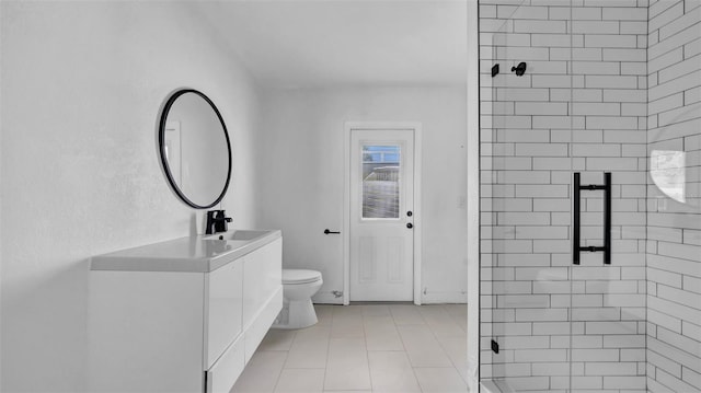 bathroom with vanity, a shower stall, and toilet