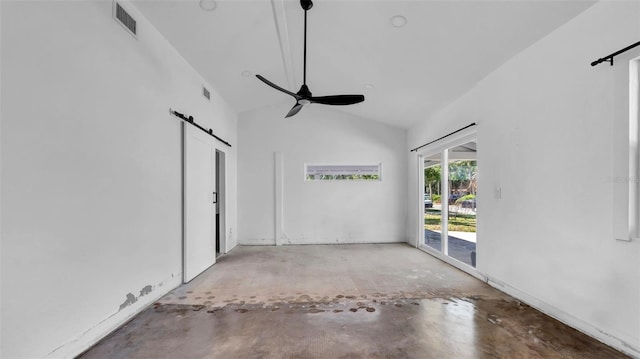 spare room featuring a barn door, visible vents, unfinished concrete flooring, and ceiling fan