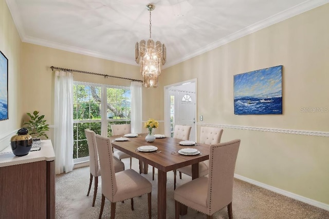 dining room with light colored carpet, crown molding, a chandelier, and baseboards