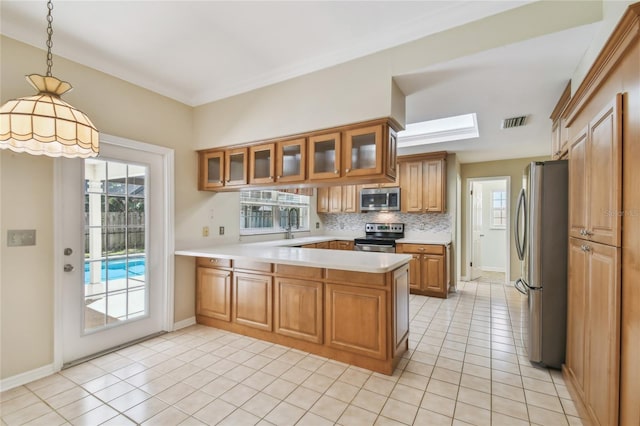 kitchen with stainless steel appliances, visible vents, a peninsula, brown cabinets, and light countertops