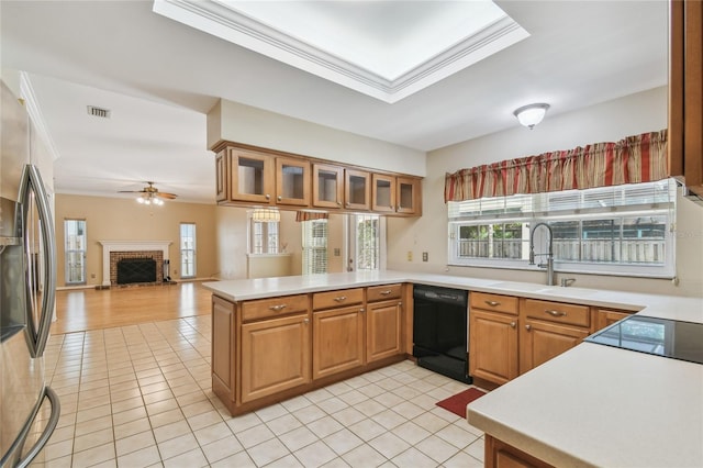 kitchen featuring a sink, a peninsula, dishwasher, ceiling fan, and stainless steel fridge with ice dispenser