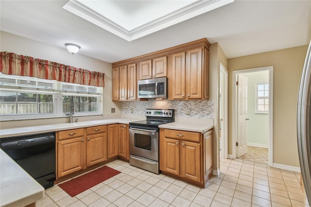 kitchen with light countertops, appliances with stainless steel finishes, light tile patterned floors, and a sink