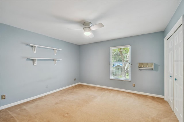 unfurnished bedroom featuring light colored carpet, a closet, and baseboards