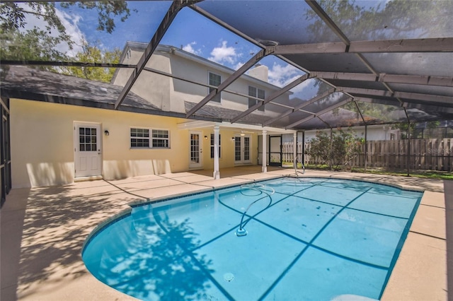 view of pool with a patio area, a fenced in pool, a lanai, and fence