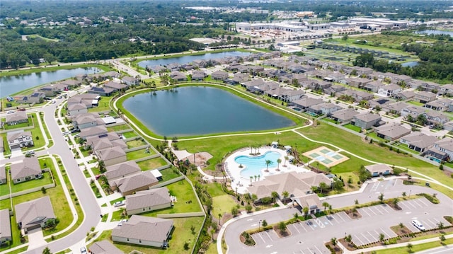 drone / aerial view with a water view and a residential view