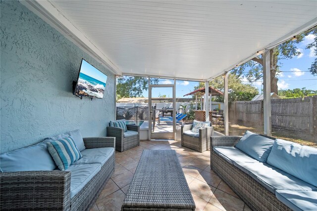sunroom featuring outdoor lounge area