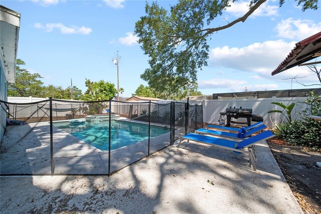 view of pool with a fenced backyard, a patio, and a pool with connected hot tub