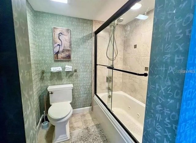 full bath featuring baseboards, a combined bath / shower with jetted tub, and toilet