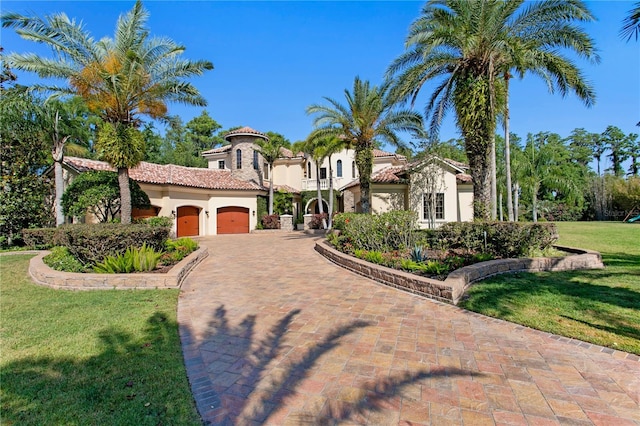 1102 Merry Water Dr, Lutz, FL 33548 - mediterranean / spanish home featuring a front lawn, a garage, stucco siding, decorative driveway, and a tiled roof