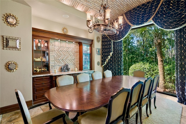 1102 Merry Water Dr, Lutz, FL 33548 - dining area with an inviting chandelier, baseboards, lofted ceiling, and brick ceiling
