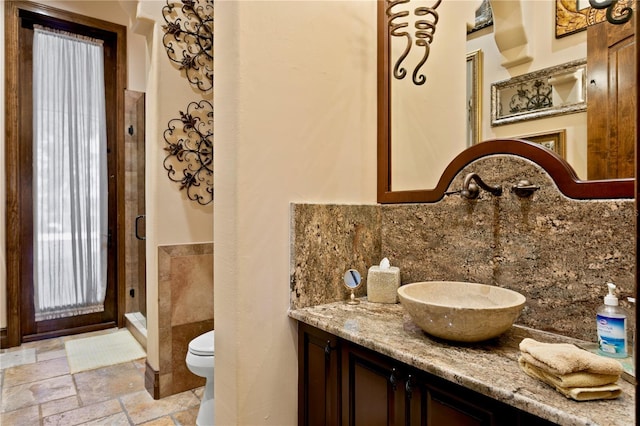 1102 Merry Water Dr, Lutz, FL 33548 - full bath featuring decorative backsplash, a shower stall, vanity, toilet, and stone tile floors