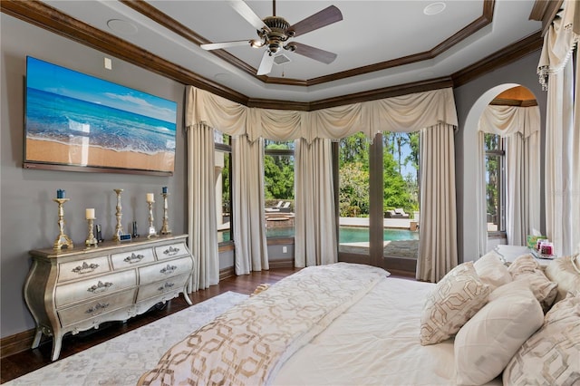 1102 Merry Water Dr, Lutz, FL 33548 - bedroom with access to outside, arched walkways, wood finished floors, a tray ceiling, and ornamental molding