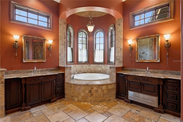 1102 Merry Water Dr, Lutz, FL 33548 - full bath featuring two vanities, a sink, a bath, and stone tile flooring