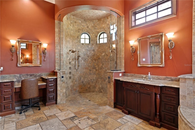 1102 Merry Water Dr, Lutz, FL 33548 - bathroom featuring vanity, a high ceiling, walk in shower, and stone tile floors