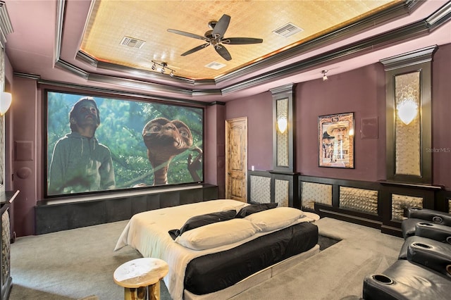 1102 Merry Water Dr, Lutz, FL 33548 - carpeted cinema featuring crown molding, a ceiling fan, a tray ceiling, and visible vents