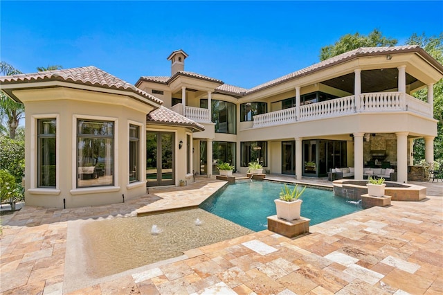 1102 Merry Water Dr, Lutz, FL 33548 - back of property with a balcony, stucco siding, an outdoor hangout area, a patio area, and a tile roof