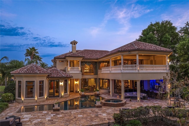 1102 Merry Water Dr, Lutz, FL 33548 - back of house with an outdoor living space, a chimney, a tile roof, a balcony, and a patio