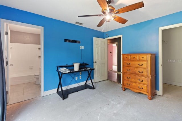 bedroom with ensuite bath, concrete floors, ceiling fan, baseboards, and visible vents