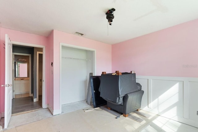 office area with visible vents and a wainscoted wall