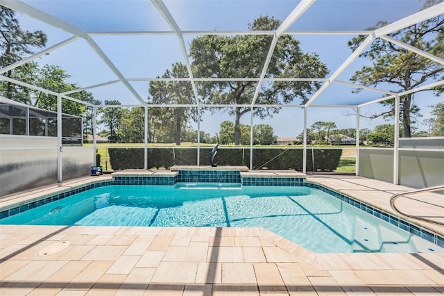 outdoor pool featuring glass enclosure and a patio area