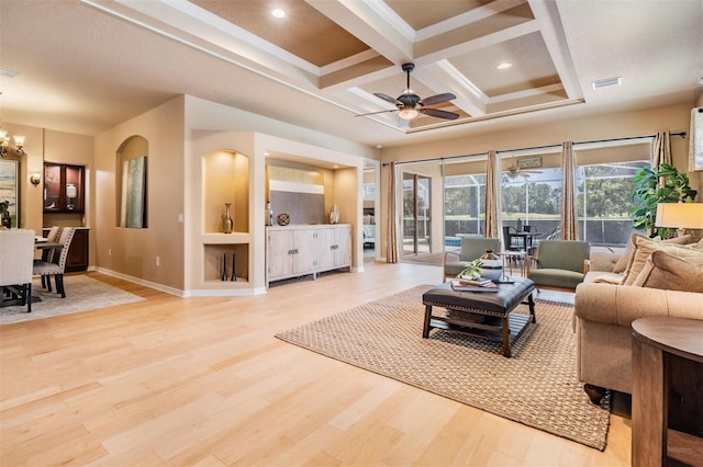 living room featuring light wood finished floors, coffered ceiling, visible vents, baseboards, and ceiling fan with notable chandelier