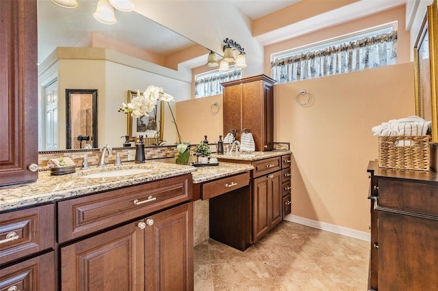 bathroom with baseboards, tile patterned flooring, and vanity