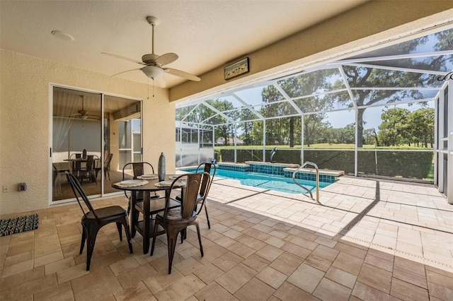 pool featuring a lanai, a ceiling fan, and a patio area