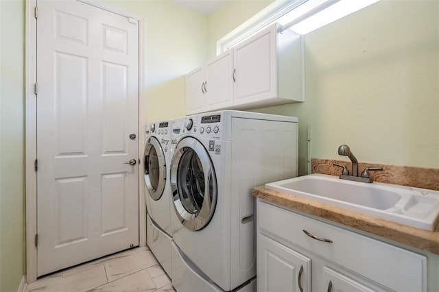 laundry area with washer and dryer, a sink, cabinet space, and marble finish floor