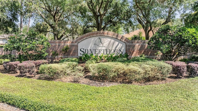 community / neighborhood sign with a lawn