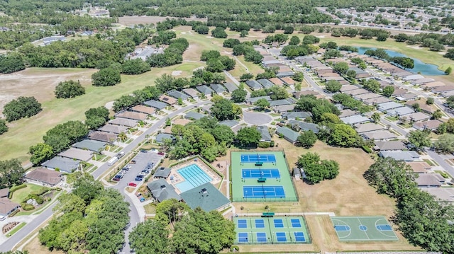 aerial view with golf course view and a water view