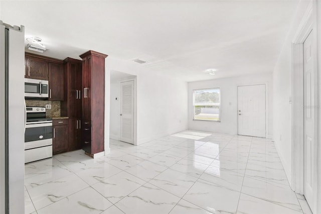 kitchen featuring visible vents, backsplash, appliances with stainless steel finishes, and marble finish floor
